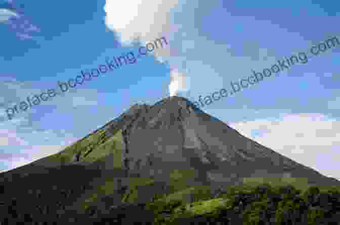 A Towering Cone Shaped Volcano Surrounded By Clouds And Lush Vegetation In Arenal Volcano National Park. Costa Rica Travel Guide With 100 Landscape Photos